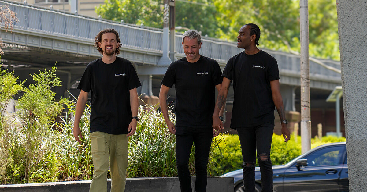 Three Premrest cleaning specialists outside a commercial building