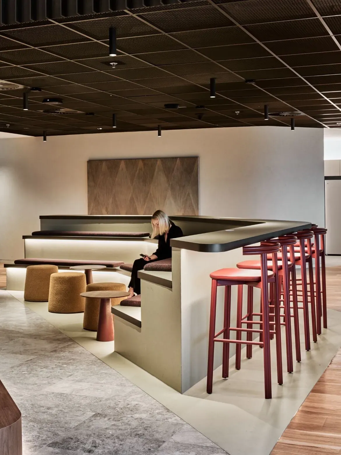 A finished office breakout space with timber and carpet